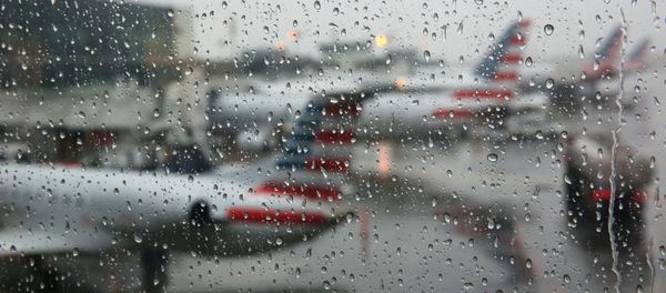 Airplanes are seen parked through a rain soaked window at their gates during a winter nor'easter at LaGuardia Airport in New York - Sputnik International