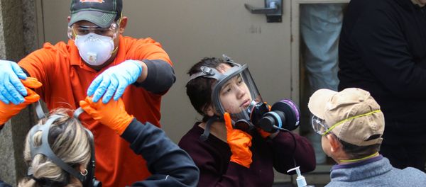 Members of a Servpro cleaning crew take off their protective gears as they exit the Life Care Center of Kirkland, the Seattle-area nursing home at the epicenter of one of the biggest coronavirus outbreaks in the United States, in Kirkland, Washington, U.S. March 11, 2020. - Sputnik International