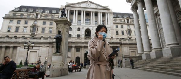 A woman, wearing a protective face mask, walks in front of the Bank of England, following an outbreak of the coronavirus, in London, Britain March 11, 2020 A woman, wearing a protective face mask, walks in front of the Bank of England, following an outbreak of the coronavirus, in London, Britain March 11, 2020 - Sputnik International