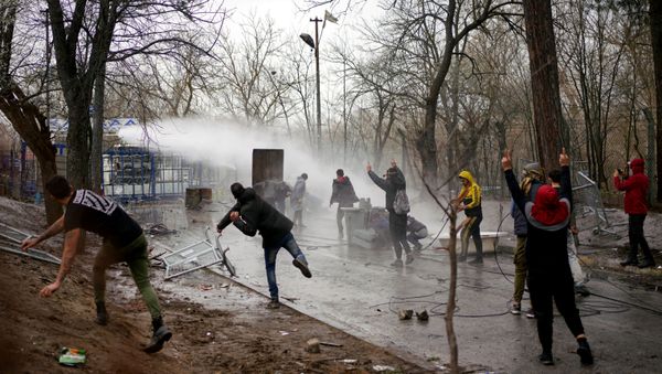 Greek riot police use a water cannon to disperse stone throwing migrants as they wait on the no man's land between Turkey and Greece, at Turkey's Pazarkule border crossing with Greece's Kastanies, in Edirne, Turkey, March 8, 2020. Greek riot police use a water cannon to disperse stone throwing migrants as they wait on the no man's land between Turkey and Greece, at Turkey's Pazarkule border crossing with Greece's Kastanies, in Edirne, Turkey, March 8, 2020. - Sputnik International