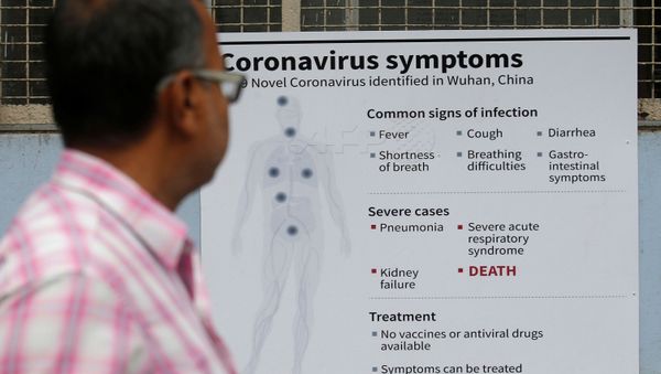 A man reads a poster carrying messages on symptoms of coronavirus disease inside hospital premises in Kolkata, India March 5, 2020.  - Sputnik International