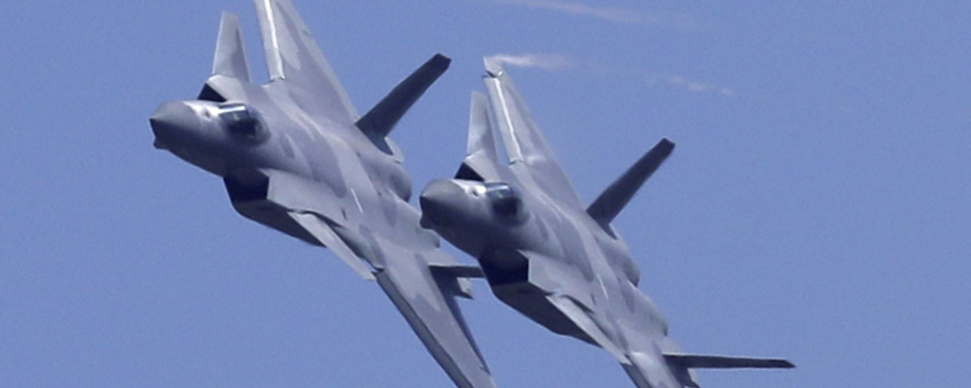 Two J-20 stealth fighter jets of the Chinese People's Liberation Army (PLA) Air Force performs during the 12th China International Aviation and Aerospace Exhibition, also known as Airshow China 2018, Tuesday, Nov. 6, 2018, in Zhuhai city, south China's Guangdong province Two J-20 stealth fighter jets of the Chinese People's Liberation Army (PLA) Air Force performs during the 12th China International Aviation and Aerospace Exhibition, also known as Airshow China 2018, Tuesday, Nov. 6, 2018, in Zhuhai city, south China's Guangdong province - Sputnik International, 1920, 06.03.2023