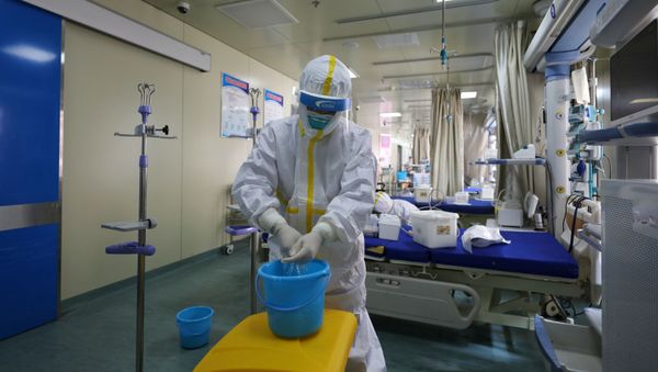 Medical workers in protective suits disinfect an intensive care unit (ICU) ward of Union Jiangbei Hospital in Wuhan, the epicentre of the novel coronavirus outbreak, Hubei province, China March 12, 2020. Picture taken March 12, 2020 - Sputnik International