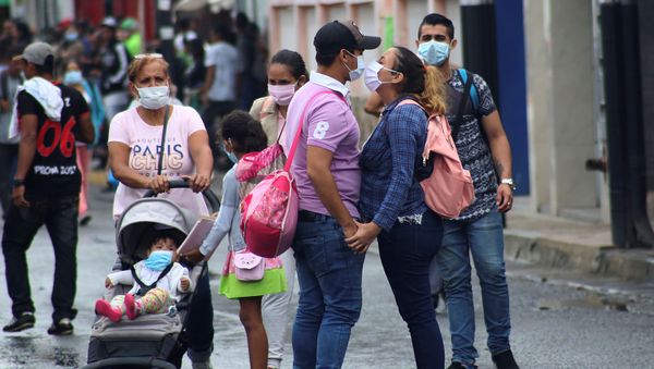 People wear face masks near the Venezuelan-Colombia border after the Colombian government decided to close the Simon Bolivar international bridge as a preventive measure in response to the spreading coronavirus disease (COVID-19) in San Antonio, Tachira, Venezuela - Sputnik International