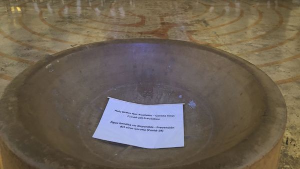 In this Saturday, March 14, 2020 photo, a sign reads, Holy Water Not Available in the baptismal font of the St. Stephen and the Incarnation Episcopal Church in Washington, which is closed due to the coronavirus pandemic. - Sputnik International