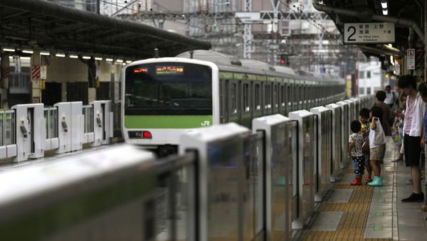 In this 17 Aug 2015 photo, people wait for a train in front of the half-height platform screen doors at Yurakucho station in Tokyo. Japan launched suicide prevention week on Thursday, 10 Sept 2015, part of a global World Health Organisation effort marking 10 Sept as World Suicide Prevention Day. - Sputnik International