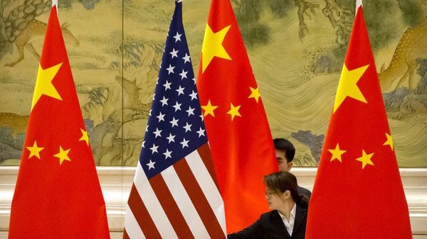 FILE - In this Feb. 14, 2019, file photo, Chinese staffers adjust U.S. and Chinese flags before the opening session of trade negotiations between U.S. and Chinese trade representatives at the Diaoyutai State Guesthouse in Beijing. Beijing on Friday, June 28, 2019 FILE - In this Feb. 14, 2019, file photo, Chinese staffers adjust U.S. and Chinese flags before the opening session of trade negotiations between U.S. and Chinese trade representatives at the Diaoyutai State Guesthouse in Beijing. Beijing on Friday, June 28, 2019 - Sputnik International