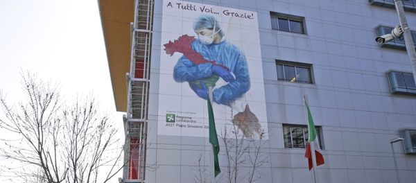 A giant image of a drawing by Venetian artist Franco Rivolli showing a doctor with wings on her back cradling Italy and writing in Italian reading To all of you... Thank you!, is displayed on the facade of Bergamo's Papa Giovanni XXIII hospital, in Bergamo, northern Italy, Monday, March 16, 2020 A giant image of a drawing by Venetian artist Franco Rivolli showing a doctor with wings on her back cradling Italy and writing in Italian reading To all of you... Thank you!, is displayed on the facade of Bergamo's Papa Giovanni XXIII hospital, in Bergamo, northern Italy, Monday, March 16, 2020 - Sputnik International