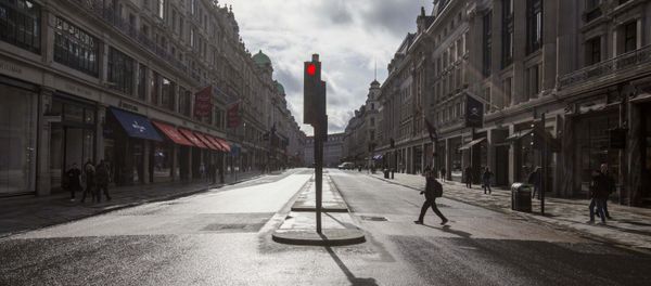 A man crosses a deserted Regent Street - usually one of London's busiest thoroughfares - Sputnik International