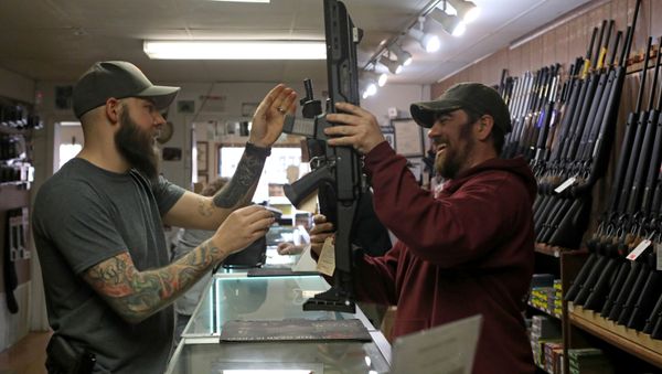 Customers handle semi-automatic rifles at Frontier Arms & Supply gun shop amid fears of the global growth of coronavirus disease (COVID-19) cases, in Cheyenne, Wyoming, U.S. March 18, 2020 - Sputnik International