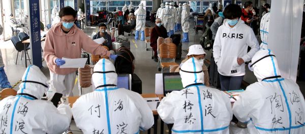 Passengers register their information at the New China International Exhibition Center, a transit hub to screen incoming passengers from the Beijing Capital International Airport for COVID-19, caused by the coronavirus, in Beijing, China March 18, 2020. Picture taken March 18, 2020 - Sputnik International