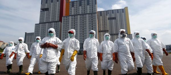 Indonesian Red Cross Society personnel walk in protective suits during an operation to spray disinfectant at the Kemayoran Athletes Village, to prevent the spread of coronavirus disease (COVID-19) in Jakarta, Indonesia, March 21, 2020. Indonesian Red Cross Society personnel walk in protective suits during an operation to spray disinfectant at the Kemayoran Athletes Village, to prevent the spread of coronavirus disease (COVID-19) in Jakarta, Indonesia, March 21, 2020. - Sputnik International
