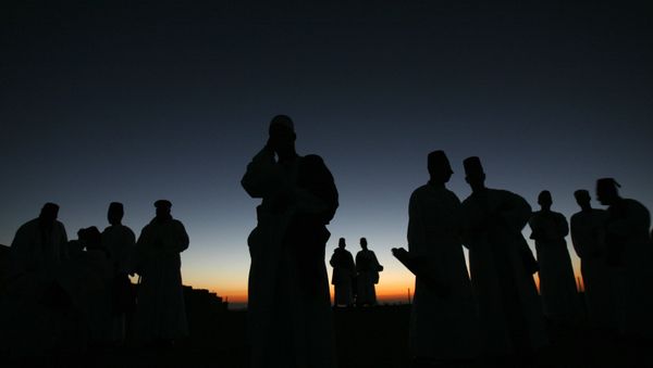 Members of the ancient Samaritan community walk to the religion's holiest site on top of Mount Gerizim near the West Bank town of Nablus, for their annual  pilgrimage for the holiday of Tabernacles or Sukkot early Monday, Oct. 13, 2008. Named for Samaria, a region in the northern West Bank, the Samaritans believe themselves to be the remnants of Israelites exiled by the Assyrians in 722 B.C. They practice a religion closely linked to Judaism and venerate a version of the Old Testament, but are not Jews. (AP Photo/Bernat Armangue) - Sputnik International