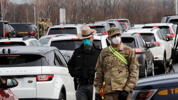 Police and U.S. Military personnel work amid a line of cars of people arriving for testing at a new drive-thru coronavirus disease (COVID-19) testing center in the Staten Island borough of New York City, New York, U.S., March 19, 2020 Police and U.S. Military personnel work amid a line of cars of people arriving for testing at a new drive-thru coronavirus disease (COVID-19) testing center in the Staten Island borough of New York City, New York, U.S., March 19, 2020 - Sputnik International