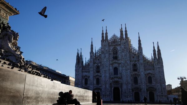 People walk through a near-empty Duomo square, usually full of people, as a coronavirus outbreak in northern Italy continues to grow, in Milan, Italy February 28, 2020. - Sputnik International