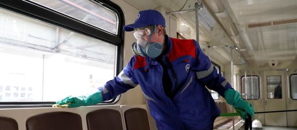 A worker cleans and disinfects a metro train as the spread of the coronavirus disease (COVID-19) continues, in Moscow, Russia March 25, 2020. - Sputnik International