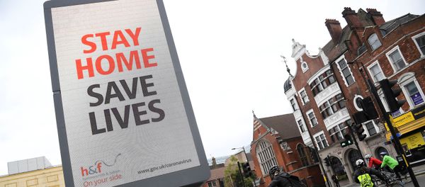 Cyclists pass an electronic billboard displaying a Public health information campaign message from the UK government and local government in London as the spread of the coronavirus disease (COVID-19) continues, London, Britain, March 28, 2020. - Sputnik International