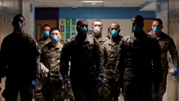 Members of Joint Task Force 2, composed of soldiers and airmen from the New York Army and Air National Guard, work to sanitize the New Rochelle High School during the coronavirus disease (COVID-19) outbreak in New Rochelle, New York, U.S., March 21, 2020 - Sputnik International
