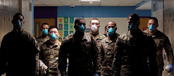 Members of Joint Task Force 2, composed of soldiers and airmen from the New York Army and Air National Guard, work to sanitize the New Rochelle High School during the coronavirus disease (COVID-19) outbreak in New Rochelle, New York, U.S., March 21, 2020 - Sputnik International