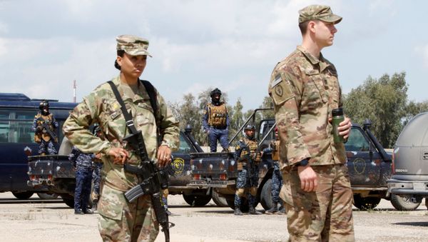 Iraqi security forces stand around their trucks behind U.S. soldiers before a handover ceremony of K-1 airbase from U.S.-led coalition forces to Iraqi security forces, in Kirkuk governorate, Iraq March 29, 2020 - Sputnik International