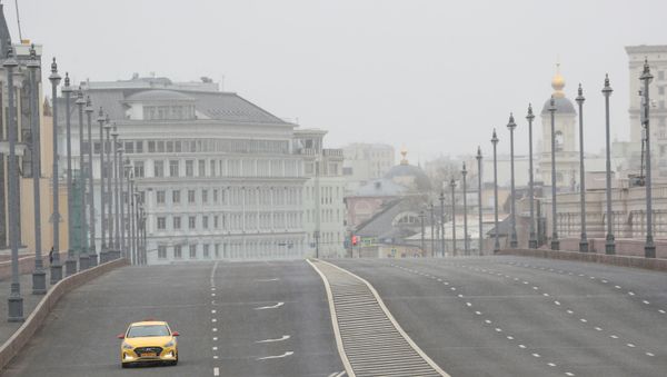 A car drives along a bridge across the Moskva River, after the city authorities announced a partial lockdown ordering residents to stay at home to prevent the spread of coronavirus disease (COVID-19), in central Moscow, Russia March 30, 2020 - Sputnik International
