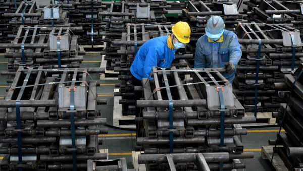 Workers wearing face masks are seen on a production line manufacturing parts for trailers to be exported to the U.S. at a factory, as the country is hit by an outbreak of the novel coronavirus disease (COVID-19), in Taizhou, Jiangsu province, China March 28, 2020. Picture taken March 28, 2020 - Sputnik International