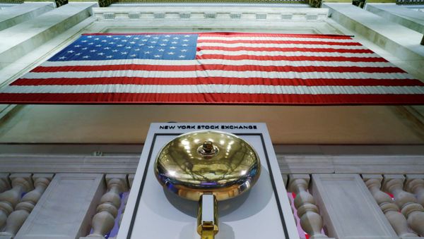 The bell used to open and close the markets hangs in front of an empty podium above the floor of the New York Stock Exchange (NYSE) as it prepares to close due to the coronavirus disease (COVID-19) outbreak in New York, U.S., 20 March 2020. The bell used to open and close the markets hangs in front of an empty podium above the floor of the New York Stock Exchange (NYSE) as it prepares to close due to the coronavirus disease (COVID-19) outbreak in New York, U.S., 20 March 2020. - Sputnik International
