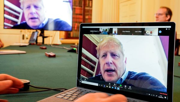 Britain's Prime Minister Boris Johnson appears on monitors for the coronavirus disease (COVID-19) meeting in London, Britain March 28, 2020. The prime minister chairs the morning update meeting on the coronavirus remotely from Number 11 Downing Street, since self-isolating after testing positive for the virus. Britain's Prime Minister Boris Johnson appears on monitors for the coronavirus disease (COVID-19) meeting in London, Britain March 28, 2020. The prime minister chairs the morning update meeting on the coronavirus remotely from Number 11 Downing Street, since self-isolating after testing positive for the virus. - Sputnik International
