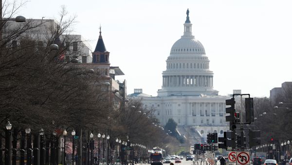People cross Pennsylvania Avenue during a morning commuter hour, as Mayor Muriel Bowser declared a State of Emergency due to the coronavirus disease (COVID-19) in Washington, U.S., March 16, 2020 - Sputnik International