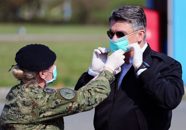 A soldier helps Croatia's President Zoran Milanovic to wear a face mask before he visits the tents which are built for patients who will have coronavirus disease (COVID-19) at Dubrava hospital in Zagreb, Croatia, March 21, 2020. A soldier helps Croatia's President Zoran Milanovic to wear a face mask before he visits the tents which are built for patients who will have coronavirus disease (COVID-19) at Dubrava hospital in Zagreb, Croatia, March 21, 2020. - Sputnik International