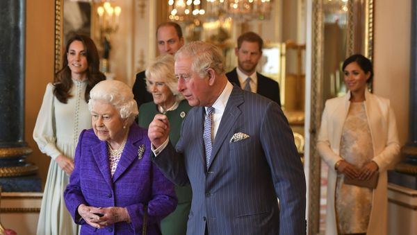 Britain's Queen Elizabeth II is joined by Prince Charles, the Prince of Wales, and at rear, from left, Kate, Duchess of Cambridge, Camilla, Duchess of Cornwall, Prince William, Prince Harry and Meghan, Duchess of Sussex during a reception at Buckingham Palace, London, Tuesday March 5, 2019, to mark the fiftieth anniversary of the investiture of the Prince of Wales - Sputnik International