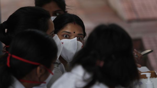 Indian doctors wearing masks at a clinic where they provide free homeopathy medicine for prevention of COVID-19 at a government run homeopathic hospital in New Delhi, India, Thursday, March 12, 2020 - Sputnik International