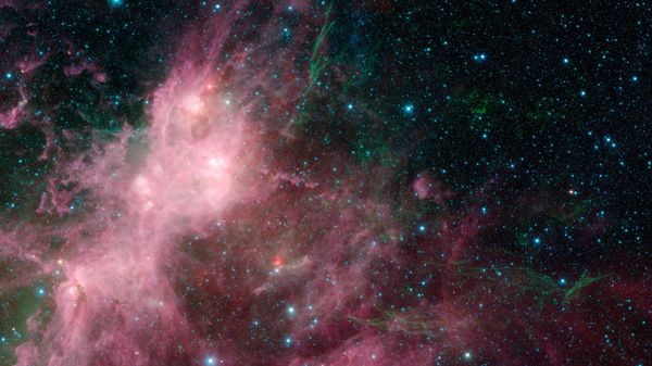 This image made available by NASA shows infrared data from the Spitzer Space Telescope and Wide-field Infrared Survey Explorer (WISE) in an area known as the W3 and W5 star-forming regions within the Milky Way Galaxy - Sputnik International