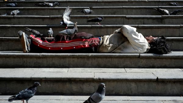 A homeless man surrounded by pigeons lies on the stairs at the Plaza San Francisco in La Paz, Bolivia, 8 March 2020 A homeless man surrounded by pigeons lies on the stairs at the Plaza San Francisco in La Paz, Bolivia, 8 March 2020 - Sputnik International