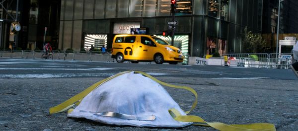 A face mask used to protect from the coronavirus disease (COVID-19) is seen on the ground near Trump Tower in New York City, New York, U.S., March 14, 2020 - Sputnik International