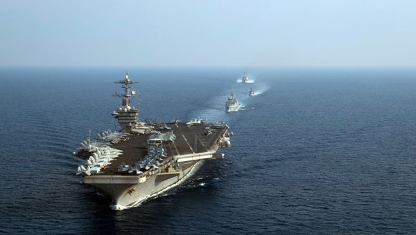 This US Navy photo obtained April 11, 2018 shows The aircraft carrier USS Theodore Roosevelt (CVN 71) leading a formation of US and Republic of Singapore navy ships during a photo exercise in the South China Sea on April 6, 2018 - Sputnik International