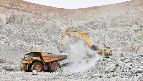 An excavator driven by Rosalie Guirou Kulga, 30, clears out rocks into a dumper at the gold mine, operated by Endeavour Mining Corporation in Hounde, Burkina Faso. Picture taken February 11, 2020.  - Sputnik International