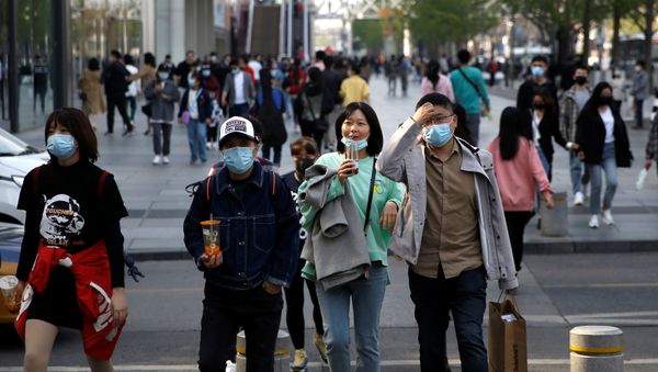 People wearing face masks are seen at a shopping area in Beijing, as the spread of the novel coronavirus disease (COVID-19) continues in the country, China April 6, 2020.  - Sputnik International