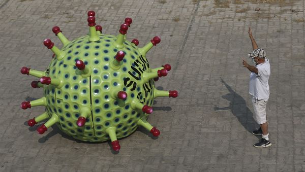 Indian car designer K. Sudhakar Yadav gestures beside a Coronavirus themed car at his museum he made as part of an awareness campaign aimed at preventing the spread of the virus in Hyderabad, India, Tuesday, April 7, 2020 - Sputnik International