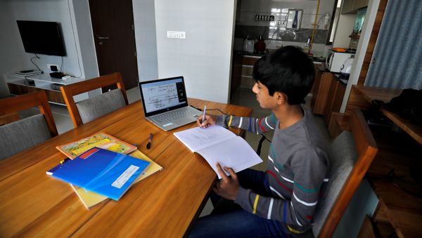 A student makes notes as he attends an online class at his home after Gujarat government ordered the closure of schools and colleges across the state amid coronavirus fears, in Ahmedabad, India, March 17,2020 A student makes notes as he attends an online class at his home after Gujarat government ordered the closure of schools and colleges across the state amid coronavirus fears, in Ahmedabad, India, March 17,2020 - Sputnik International