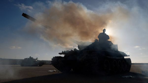 Members of Libyan National Army (LNA) commanded by Khalifa Haftar, get ready before heading out of Benghazi to reinforce the troops advancing to Tripoli, in Benghazi, Libya April 13, 2019. - Sputnik International