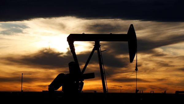 The sun sets behind a crude oil pump jack on a drill pad in the Permian Basin in Loving County, Texas, U.S. November 24, 2019 The sun sets behind a crude oil pump jack on a drill pad in the Permian Basin in Loving County, Texas, U.S. November 24, 2019 - Sputnik International