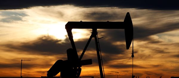 The sun sets behind a crude oil pump jack on a drill pad in the Permian Basin in Loving County, Texas, U.S. November 24, 2019 - Sputnik International