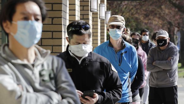 Customers wear a variety of protective masks as they wait some six-feet apart to enter a Trader Joe's store, where the number of customers allowed inside at any one time was limited because of the coronavirus outbreak, Wednesday, April 8, 2020, in Seattle - Sputnik International