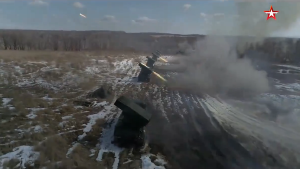 Russian Army BM-21 Grad multiple launch rocket systems bombard a simulated enemy target during drills in the Eastern Military District - Sputnik International