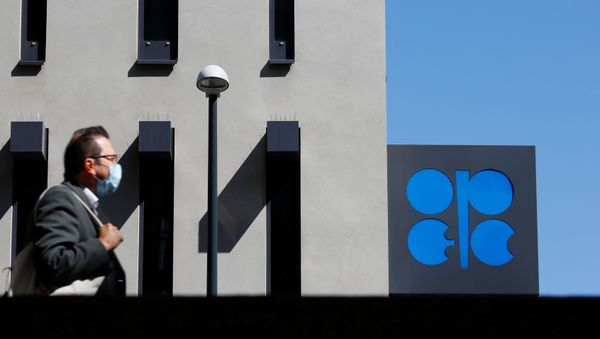 A person passes the logo of the Organization of the Petroleoum Exporting Countries (OPEC) in front of OPEC's headquarters in Vienna, Austria April 9, 2020 - Sputnik International