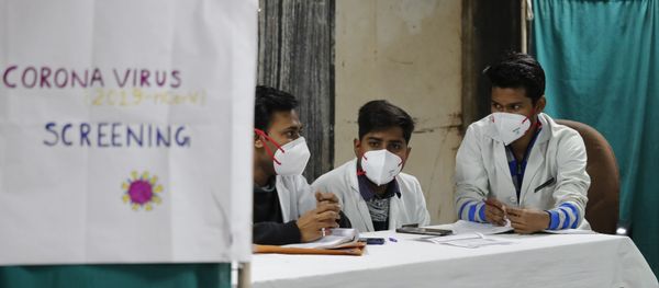 Indian doctors wait in an area set aside for possible COVID-19 patients at a free screening camp at a government run homeopathic hospital in New Delhi, India, Friday, March 13, 2020 Indian doctors wait in an area set aside for possible COVID-19 patients at a free screening camp at a government run homeopathic hospital in New Delhi, India, Friday, March 13, 2020 - Sputnik International