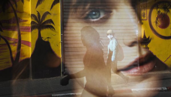 A woman is reflected on a bus station as she wears a protective face mask amid concerns over the country's coronavirus outbreak, in Tel Aviv, Israel, Monday, April 6, 2020. A woman is reflected on a bus station as she wears a protective face mask amid concerns over the country's coronavirus outbreak, in Tel Aviv, Israel, Monday, April 6, 2020. - Sputnik International