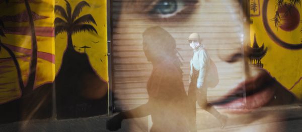 A woman is reflected on a bus station as she wears a protective face mask amid concerns over the country's coronavirus outbreak, in Tel Aviv, Israel, Monday, April 6, 2020.  - Sputnik International