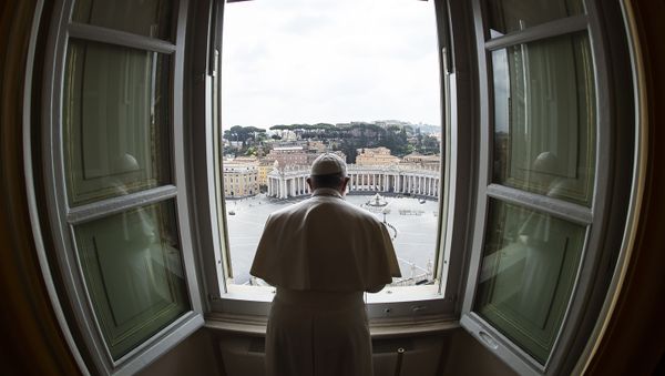 This handout photo taken on 29 March 2020 and released by the Vatican press office, the Vatican Media, shows Pope Francis praying from the window of the Apostolic Palace overlooking an empty St. Peter' Square after livestreaming the Angelus prayer at the Vatican.  - Sputnik International